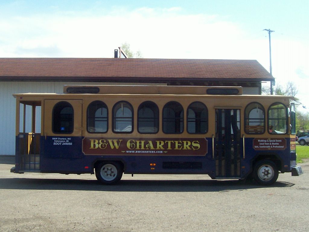B&W Charters trolley bus parked by building