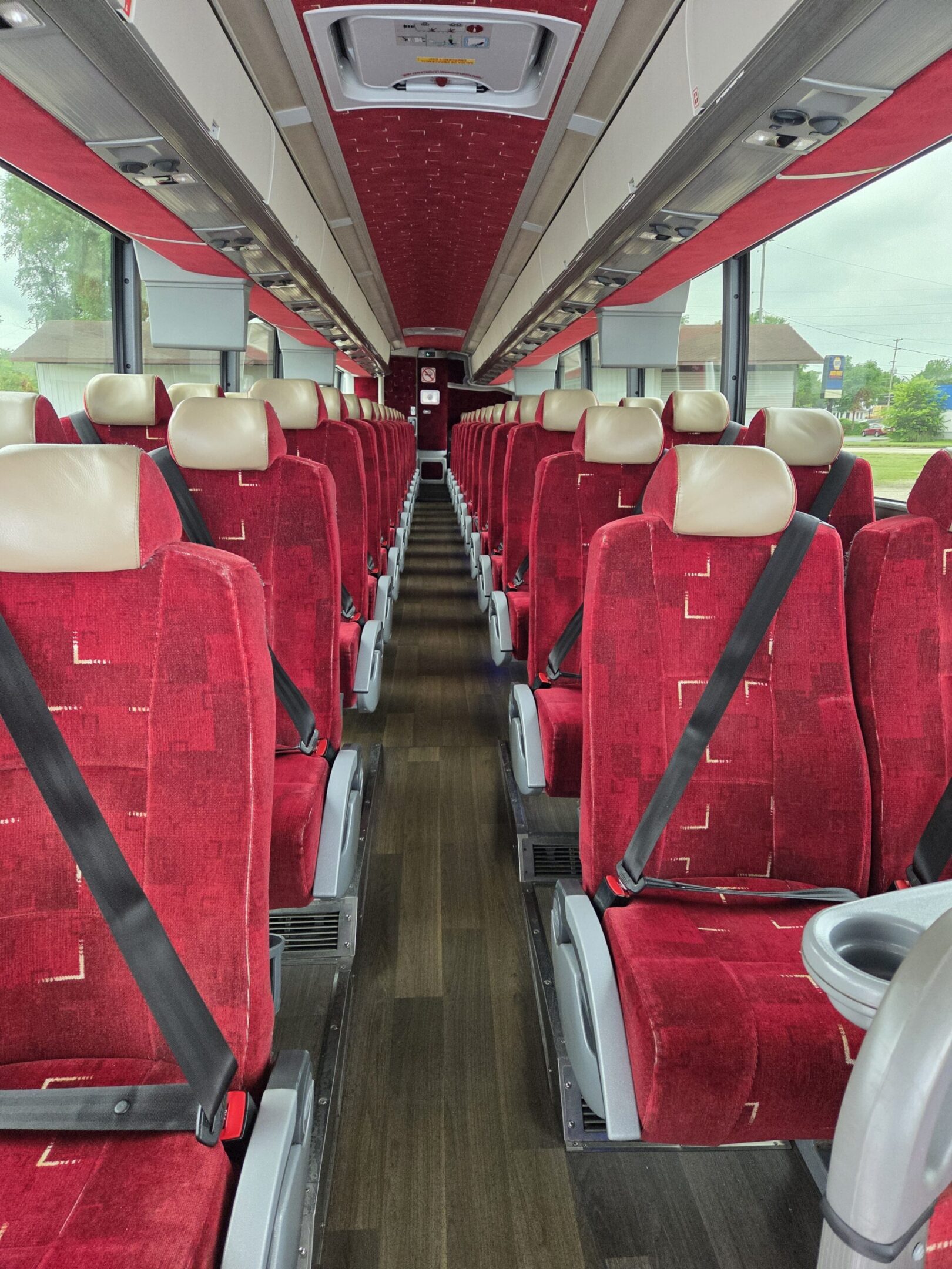 Empty coach bus interior with red seats