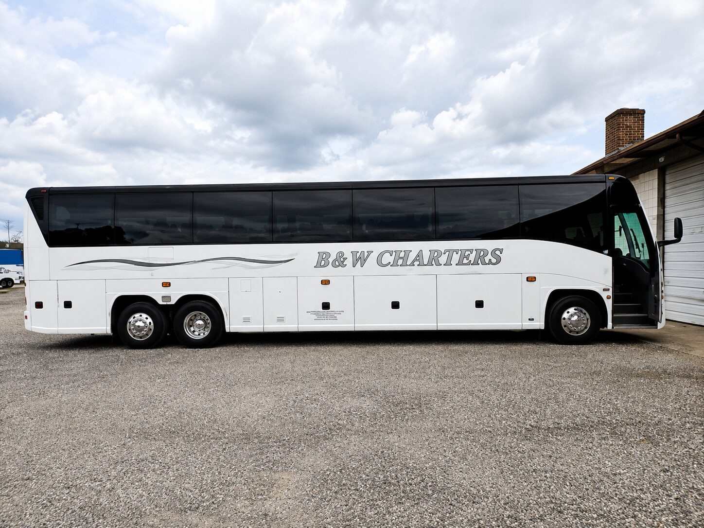 White B&W Charters coach bus parked outside
