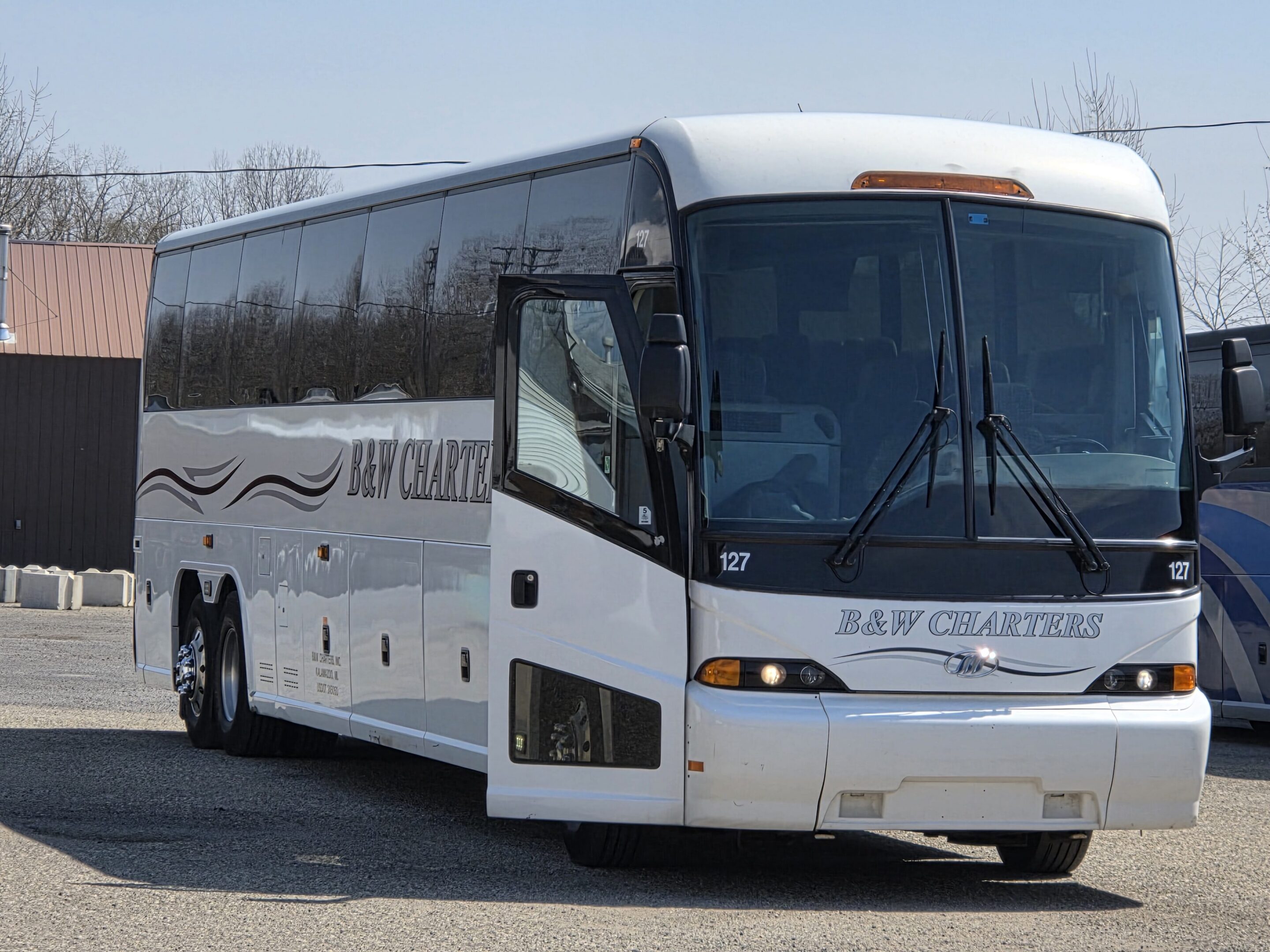 White charter coach bus parked in lot