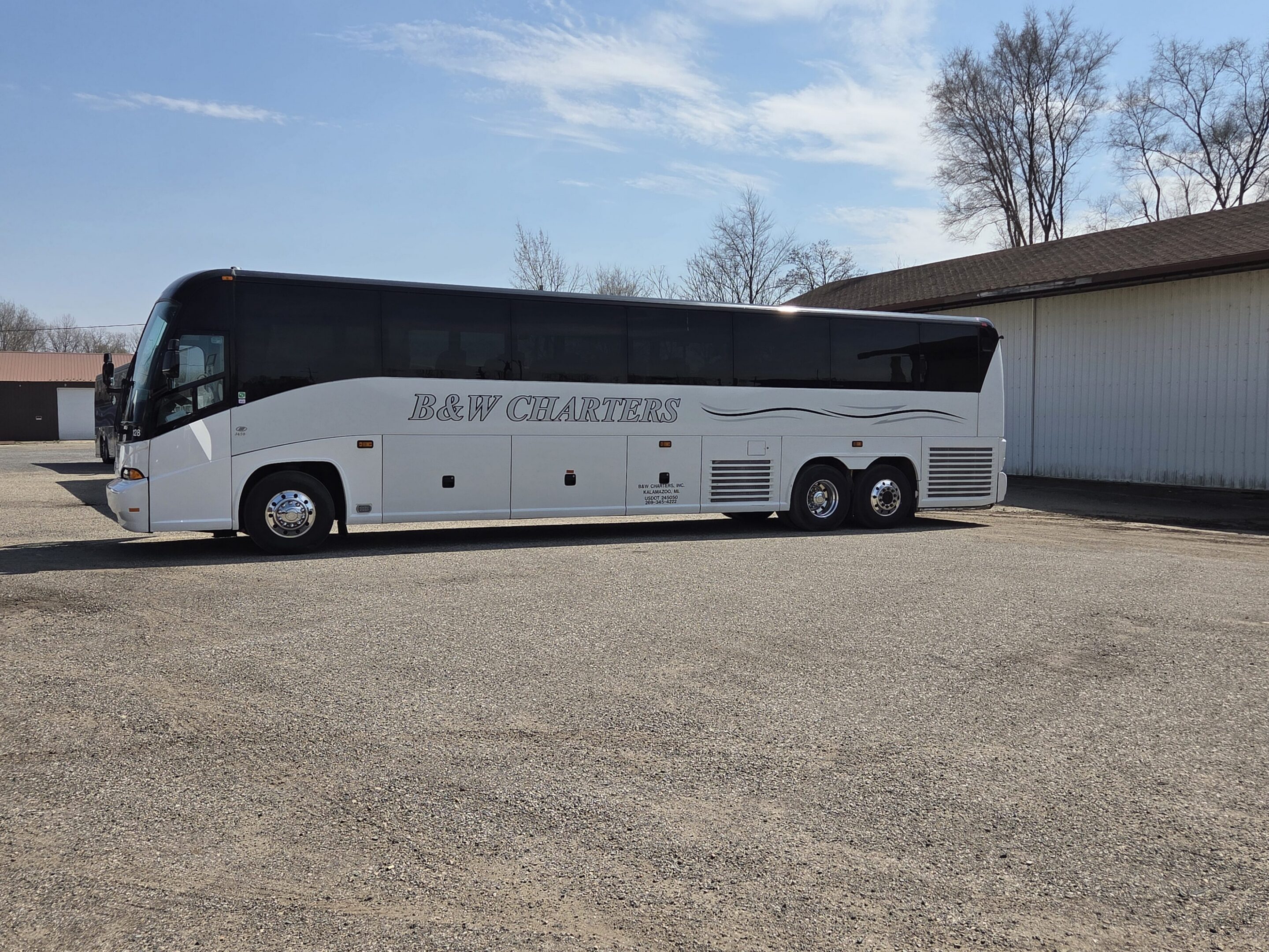 White charter coach bus parked near building
