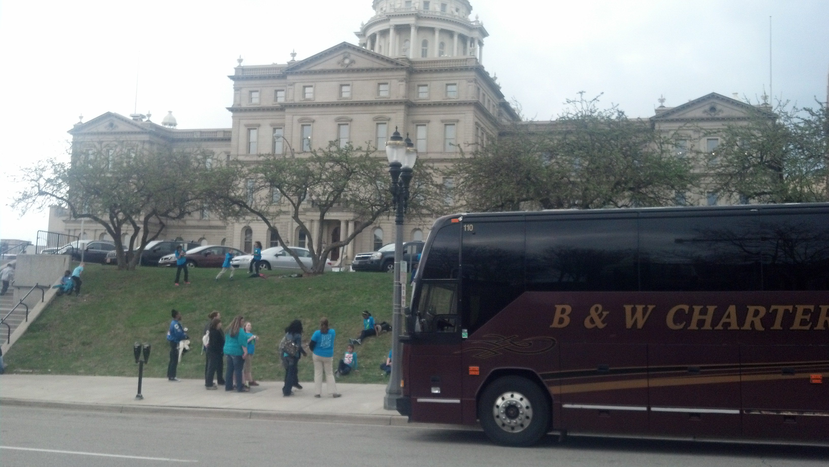 Charter bus and people by capitol building