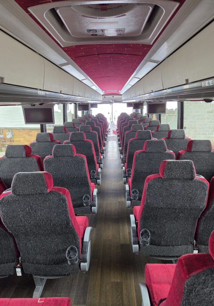 Rows of red and grey bus seats